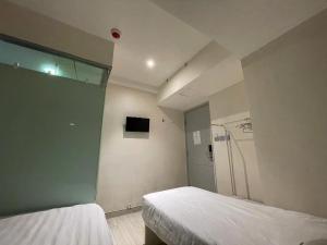 Voodi või voodid majutusasutuse 珀依旅馆 Pop E INN toas