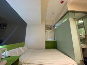 Voodi või voodid majutusasutuse 珀依旅馆 Pop E INN toas