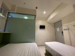 Voodi või voodid majutusasutuse 珀依旅馆 Pop E INN toas