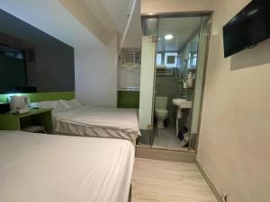 Voodi või voodid majutusasutuse 珀依旅馆 Pop E INN toas