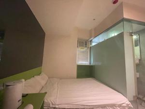 Voodi või voodid majutusasutuse 珀依旅馆 Pop E INN toas