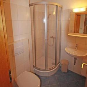 a bathroom with a shower and a toilet and a sink at Morgenroete in Lemkenhafen auf Fehmarn