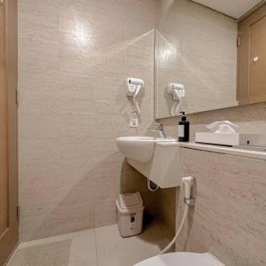 La salle de bains est pourvue d'un lavabo et de toilettes. dans l'établissement Studio, West Jakarta Oasis, Netflix, Pool, Mall, à Jakarta