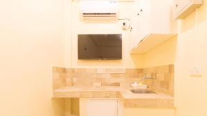 a small kitchen with a sink and a counter at RedDoorz at V-Cloud Hills near De La Salle Dasmarinas Cavite in Dasmariñas