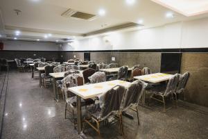 an empty dining room with tables and chairs at Hotel Kabir Palace Karol Bagh in New Delhi