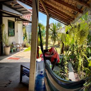 a hammock in a house with plants in it at Ozone Beach House in Ko Lanta