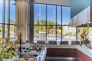 a dining room with a view of a marina at Hotel Mikołajki Leisure & SPA - Destigo Hotels in Mikołajki +41 photos