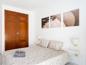 a bedroom with a bed and a picture on the wall at Live Medano Mirazul in El Médano +14 photos
