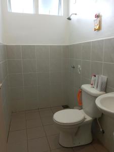 a bathroom with a toilet and a sink at Khayla Homestay in Kuah +23 photos