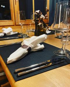 a wooden table with silver utensils on top at Restaurant Hotel Schermtanne in Adelboden