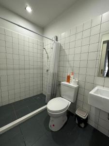 a bathroom with a toilet and a shower and a sink at PIER 808 Hostel in Bangkok