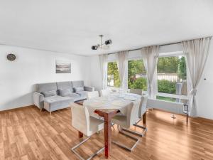 a living room with a table and a couch at Work & Stay in Adelheitsdorf in Adelheidsdorf