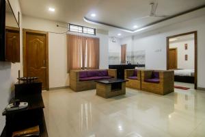 a living room with couches and a bed at Super Collection O The Blu Bell Nizarapar Path in Guwahati