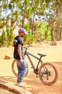 Un uomo è in piedi accanto a una bicicletta di Oceanis Park Andakana a Andakana