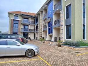 a car parked in a parking lot in front of a building at TREAT HOMIES in Kira