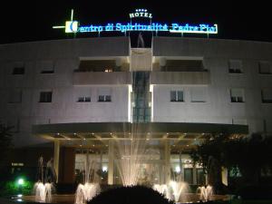 a hotel with a fountain in front of a building at Hotel Centro di Spiritualità Padre Pio in San Giovanni Rotondo