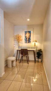 a living room with a desk and a chair at Penthouse-level Waterfront Apartment in Darwin