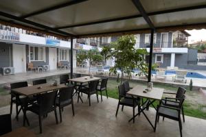 a patio with tables and chairs and a pool at GREEN GARDEN ALLGAU HOTEL in Pamukkale