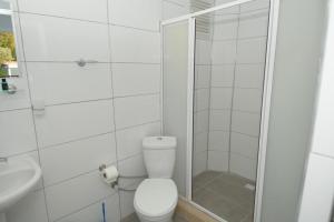 a white bathroom with a toilet and a shower at GREEN GARDEN ALLGAU HOTEL in Pamukkale