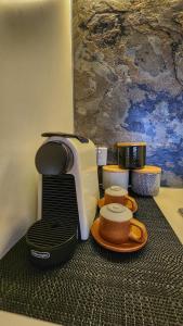 a coffee maker sitting on top of a table at Penthouse-level Waterfront Apartment in Darwin