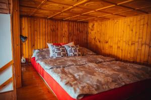 a bed in a room with a wooden ceiling at nocleg w Krośnie blisko dworca in Krosno