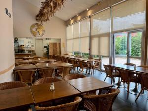 a dining room with wooden tables and chairs at Résidence Otellia in Blanquefort