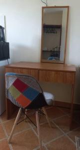 a wooden desk with a mirror and a chair at Adhiambo's Studio near Bofa Beach in Kilifi