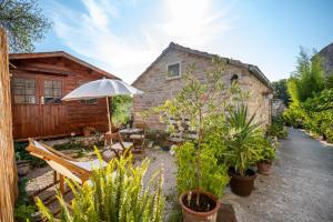 a patio with an umbrella and some plants at Stone House Harmony in Korčula