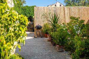 a garden with potted plants and a fence at Stone House Harmony in Korčula