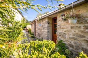 a stone building with a door and plants at Stone House Harmony in Korčula