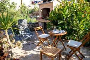 a patio with a table and chairs and a fireplace at Stone House Harmony in Korčula