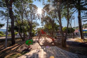 a playground in a park with the sun shining at Stone House Harmony in Korčula