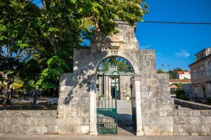 an entrance to a stone building with a gate at Stone House Harmony in Korčula