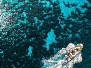 a boat in the middle of the blue water at Stone House Harmony in Korčula