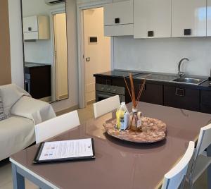 a living room with a table and a kitchen at Residence Del Lago in Desenzano del Garda