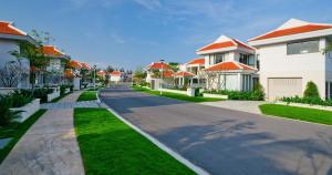a residential street with houses and grass at Ocean Beach Villas Danang in Da Nang