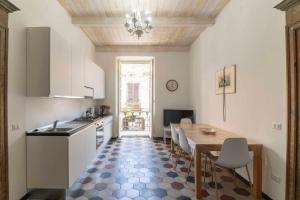 a kitchen with a table and a dining room at Vintage Cavour Apartment in Sassari