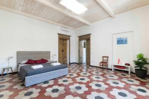 a large bedroom with a bed and a checkered floor at Vintage Cavour Apartment in Sassari
