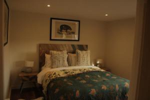 a bedroom with a bed with a green comforter at White Swan Inn in Belford