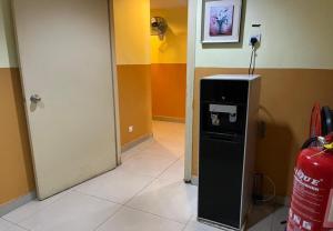 a room with a small refrigerator in a room at Sun Inns Hotel Kota Damansara Near Hospital Sungai Buloh in Kota Damansara