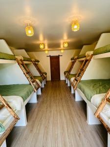 a room with four bunk beds in it at The Hideout Samui in Koh Samui 