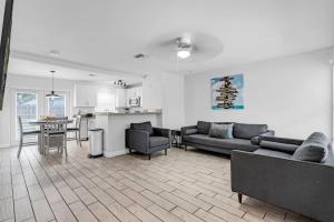 a living room with two couches and a kitchen at Trendy Family Home -Heated Pool in Hollywood