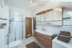 a bathroom with a sink toilet and a shower at Vitaloase Bad Griesbach im Rottal/70qm/Auszeit/Parkplatz in Bad Griesbach +49 photos