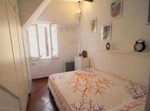 a bedroom with a bed and a window at La casa nel cuore di Camogli in Camogli