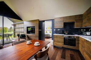 a kitchen with a wooden table in a room at Feldon Valley in Lower Brailes