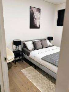 a bedroom with a bed and a table in a room at Urban Oasis: Central Wollongong in Wollongong