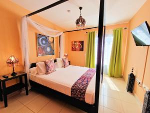 a bedroom with a bed and a large mirror at Suite Marrakech Beach, La Graciosa. in Caleta de Sebo