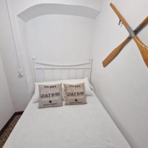 two pillows sitting on a bed in a room at Arsenal Azul in Villajoyosa +32 photos