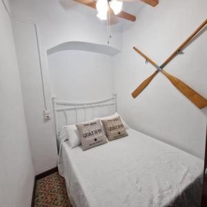 a bedroom with a bed with two pillows on it at Arsenal Azul in Villajoyosa