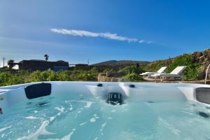 a hot tub in the backyard of a house at Tenuta Bukkuram in Pantelleria